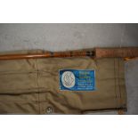 An Edgar Sealey three piece split cane fly rod 9ft 6in long with spare tip in original sleeve
