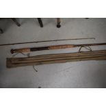 A vintage 12ft cane rod with spare tip in sleeve, unmarked