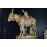 A Royal Dux figural group study of two donkeys stamped with lozenge to base (damage to one ear)