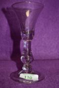 A trumpet bowl wine glass having baluster stem with a basal knop over a domed and folded foot