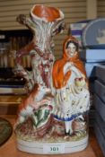 A ceramic Staffordshire figure base or spill vase depicting Little red riding hood and wolf