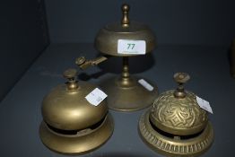 Three vintage brass shop or desk top bells.