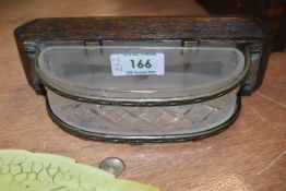 A frosted glass ash tray or similar, with metal and oak wall mounting, possibly from a railway or