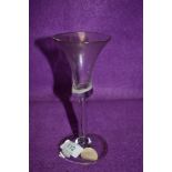 A wine glass having trumpet bowl with opaque enamel (possibly a twist gone wrong?) with elongated