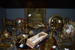 A collection of brass including candlesticks, horse brasses, belt buckle,billows,trivets and and