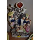 A Staffordshire flat back figure 'The Rival' depicting a scene of three people and a tree.