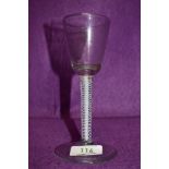 A funnel bowl wine glass on an opaque multi spiral stem surrounding a central solid white stem 16cm