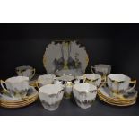 A stunning Shelley 'Sunrise and tall trees' part tea set comprising of eight Queen Anne shaped cups,