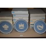 A large quantity of Wedgewood display plates in boxes, including those of christmas and London