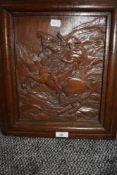 A hand carved oak plaque depicting Napoleon on horse back carved Bonapart carved by A Tancook with