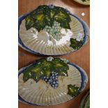 Two dramatic shell shaped dishes with raised grape and vine hand painted designs. bearing the name