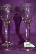 A pair of plain stem wine glasses circa 1735 having fluted decoration to the base of the bowl with