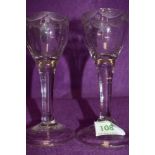 A pair of plain stem wine glasses circa 1735 having fluted decoration to the base of the bowl with