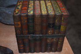 A collectable antique Huntley and Palmer biscuit tin fashioned in the form of library books, bound