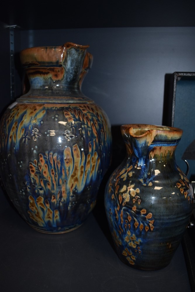 Two British studio pottery jugs by local potter John Calver hand thrown and decorated in blue