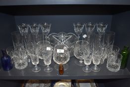 A selection of clear cut crystal glass wares including fruit bowl, brandy and wine glasses