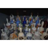A large collection of ceramic and similar bells, various patterns and designs.