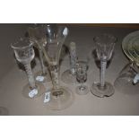 A collection of six antique glass including etched wine glasses with multi spiral twists to stems,