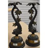 A pair of mantle or side table figural lamp bases of classical mythical sea beasts cast in solid