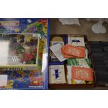 A collection of games,including cards, dominoes and two unopened jigsaws.