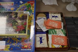 A collection of games,including cards, dominoes and two unopened jigsaws.