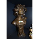 A bronze effect figural bust of a lady having Art Nouveau styled design