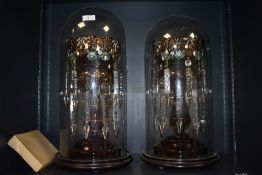A pair of 19th century cranberry glass and lustre mantle garnitures having gilt and hand worked