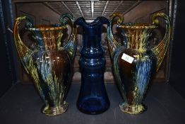 A pair of Victorian twin handle mantle urns having multi colour glaze and blue glass hand blown