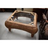 A modern wicker and glass coffee table, approx. 70 x 80cm