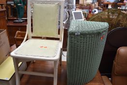 A vintage corner linen basket, probably Lloyd Loom and a vintage painted chair with integral unders