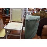 A vintage corner linen basket, probably Lloyd Loom and a vintage painted chair with integral unders