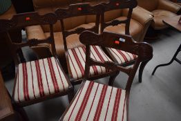 A set of four reproduction mahogany rail back dining chairs