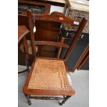 A late Victorian stained frame bedroom chair, having typical cane seat on turned frame