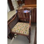 A traditional mahogany rail back carver chair, late Victorian or Edwardian, has had worm and been