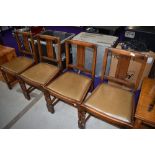 A set of four early to mid 20th Century oak dining chairs