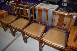 A set of four early to mid 20th Century oak dining chairs