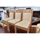 Three modern dining chairs, upholstered seats and backs