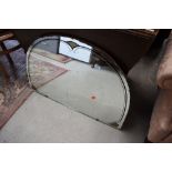 An Art Deco style frameless arched wall mirror, width approx. 88cm