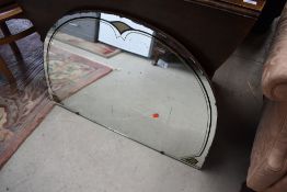 An Art Deco style frameless arched wall mirror, width approx. 88cm