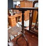 A traditional oak pedestal wine table, diameter approx 30cm, some repair and warping