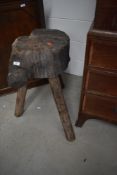 A rustic wooden chopping block on legs , height approx. 76cm
