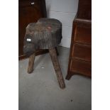 A rustic wooden chopping block on legs , height approx. 76cm