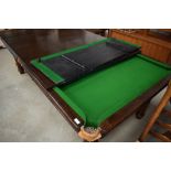 A traditional Riley snooker table, having accesories and dining top, appears quite low, probably