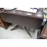 A 19th Century stained frame table, having drop flap, frieze drawer, on turned pedestal over