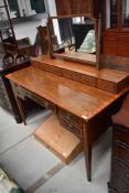 An Edwardian inlaid dressing table of classical design, having full width jewellery drawer based