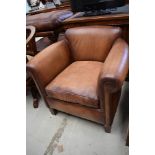 A modern brown leather tub chair