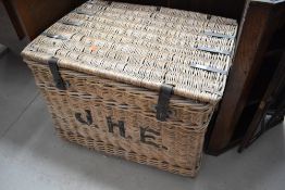 A vintage laundry hamper, bearing monogram J.H.E., approx. width 85cm