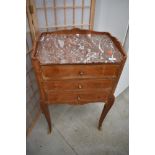 A Continental Kingswood three drawer side cabinet having rouge marble top, ormolu handles and foot