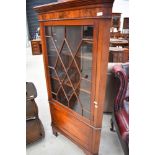 An Edwardian mahogany full height corner display cabinet having astral glazed top with cupboard base