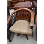 A hardwood swivel chair with suede style cushion